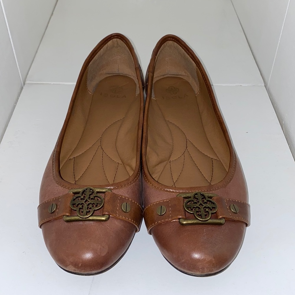 Brown leather flats with decorative bronze trim